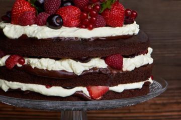 Chocolate cake with whipped cream and fruit